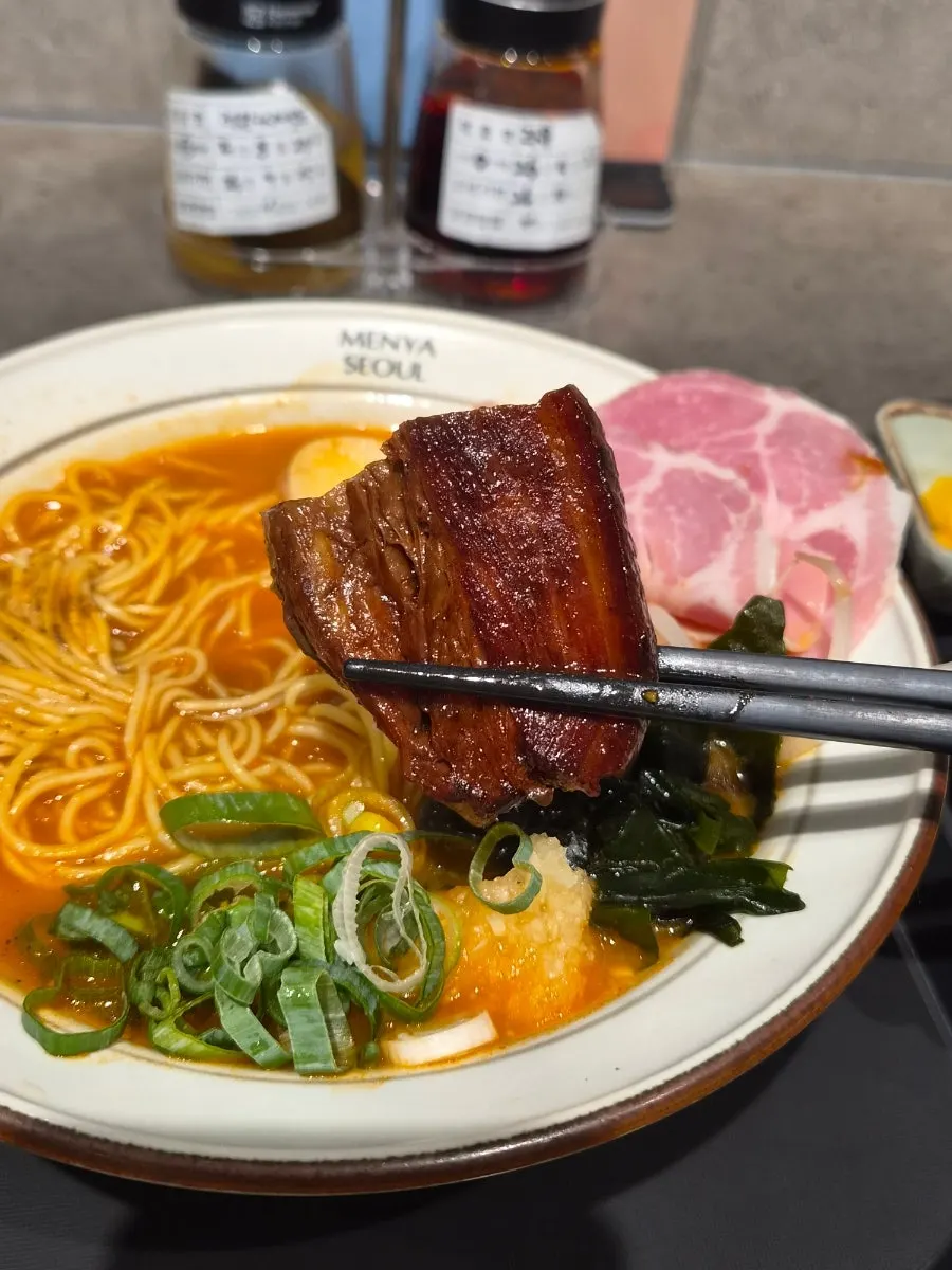 A bowl of mazesoba topped with pork belly