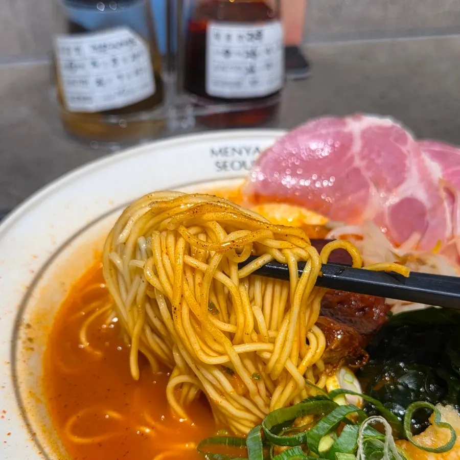 Dongpo pork chashu and jambon toppings on spicy ramen