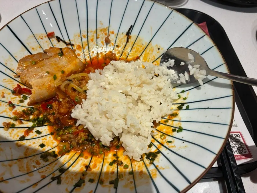An extra bowl of rice ordered on the side