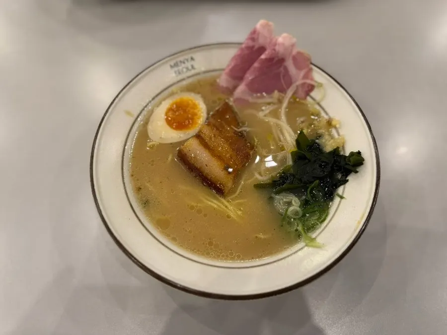 Two bowls of ramen served with side set