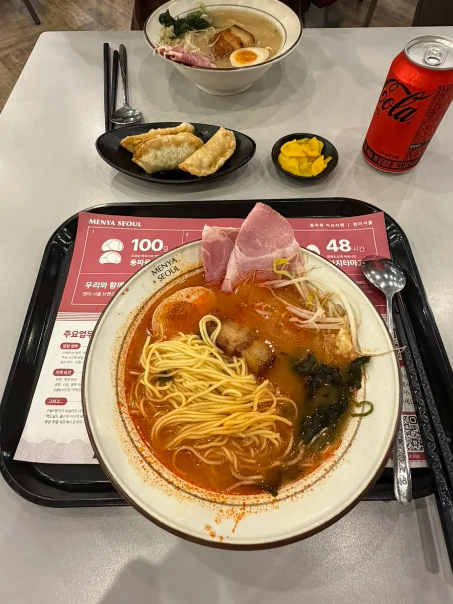 Noodles lifted up with dongpo pork on the ramen