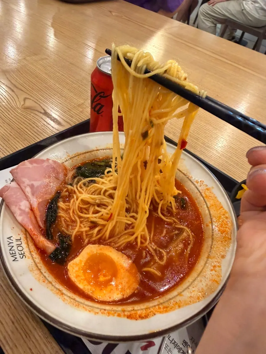 Table with two bowls of ramen and sides
