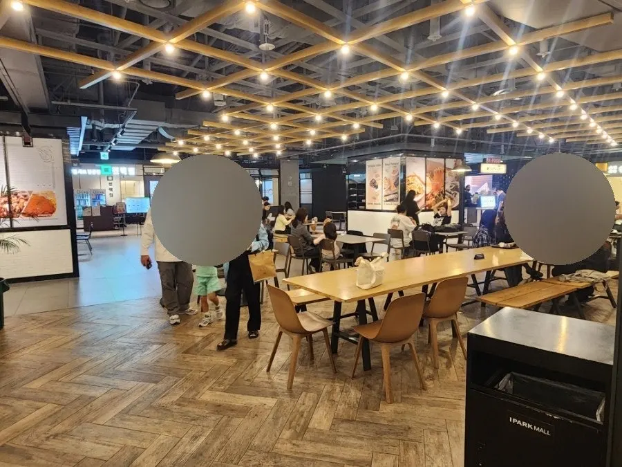 Bar seats facing the kitchen and food court tables