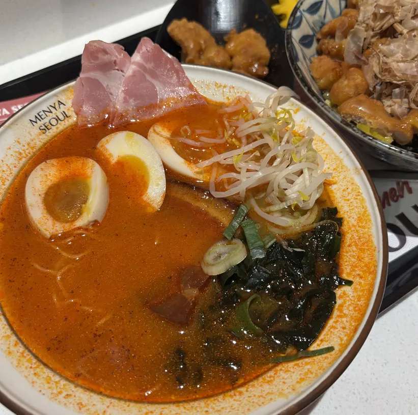 Close-up of the spicy broth dongpo pork ramen's broth and toppings