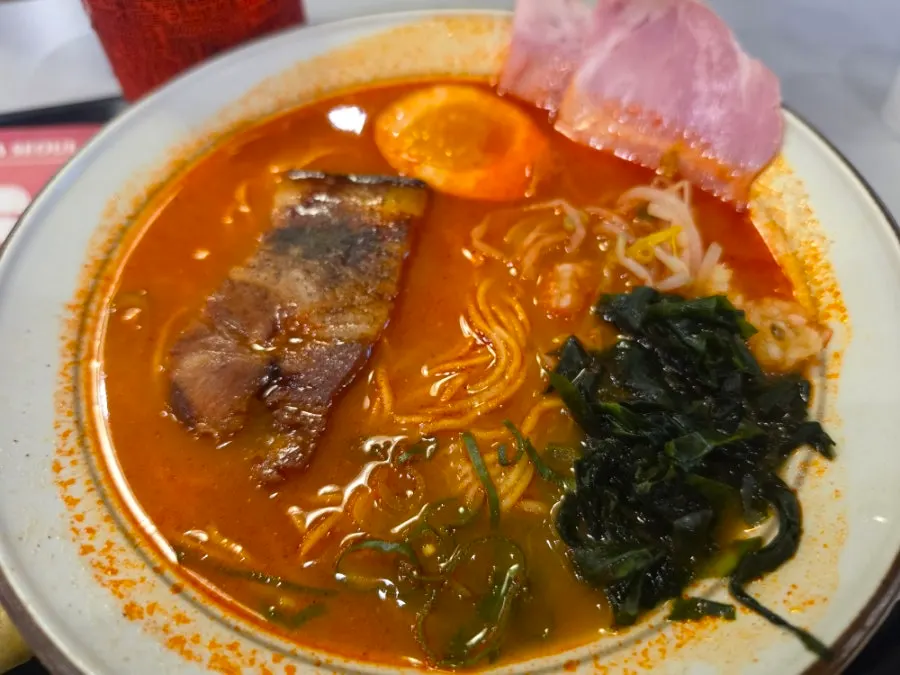 Spicy ramen topped with dongpo pork and jambon chashu