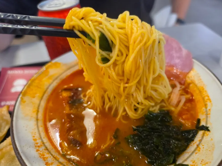 Ramen broth with half an ajitama and seaweed
