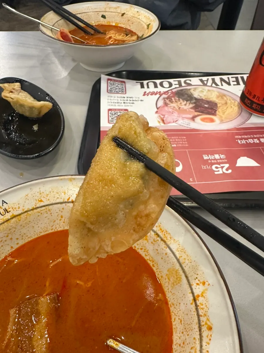 Spicy red ramen broth with a soft-boiled egg