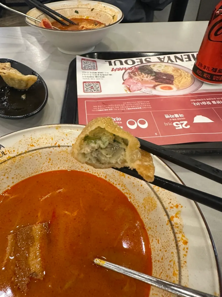 Gyoza dumpling dipped into the ramen broth