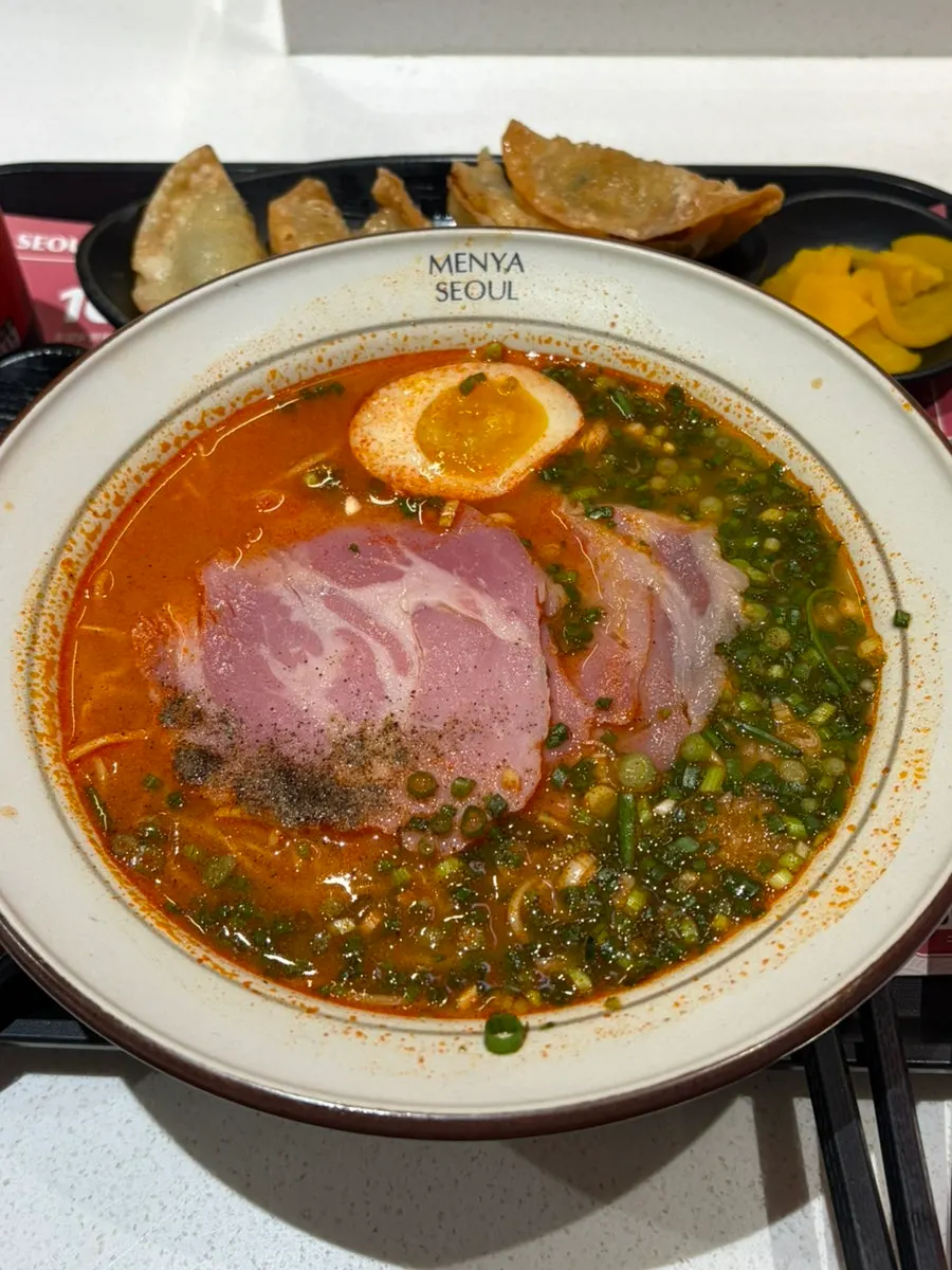 Spicy ramen topped with soft-boiled egg and jambon
