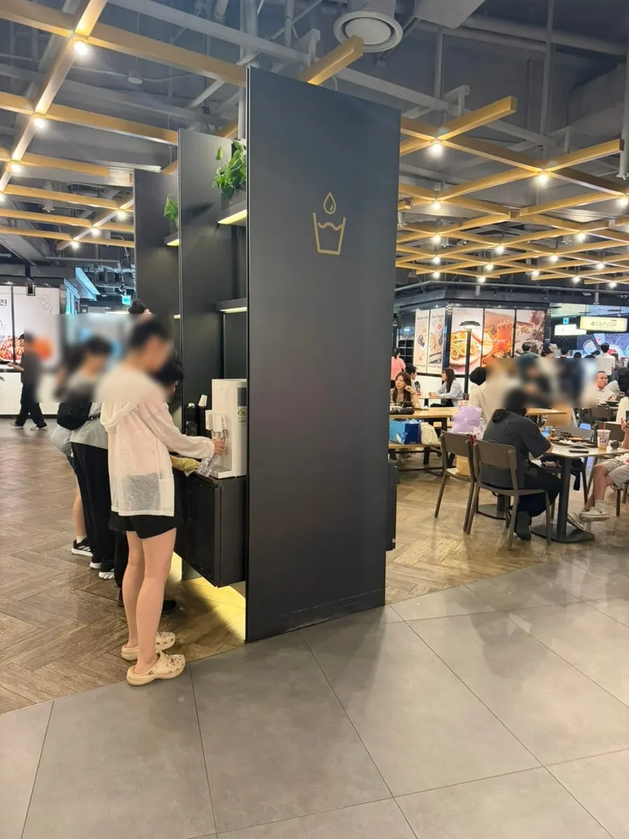 Self-serve water dispenser with paper cups
