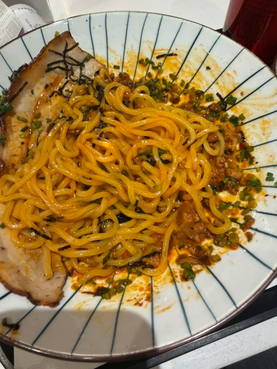 Mazesoba noodles mixed with the popped egg yolk