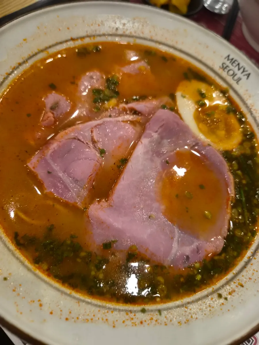 Spicy broth jambon ramen with half a boiled egg