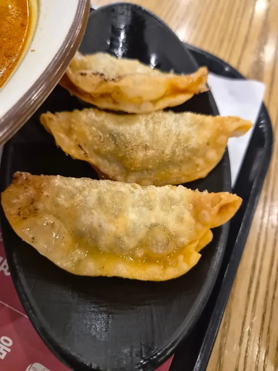 Three crispy gyoza served as a side