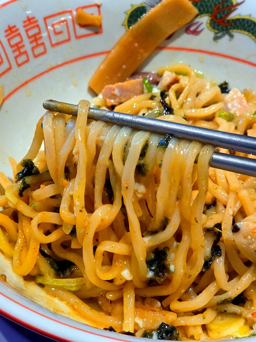 A bite of abura soba wrapped in seaweed