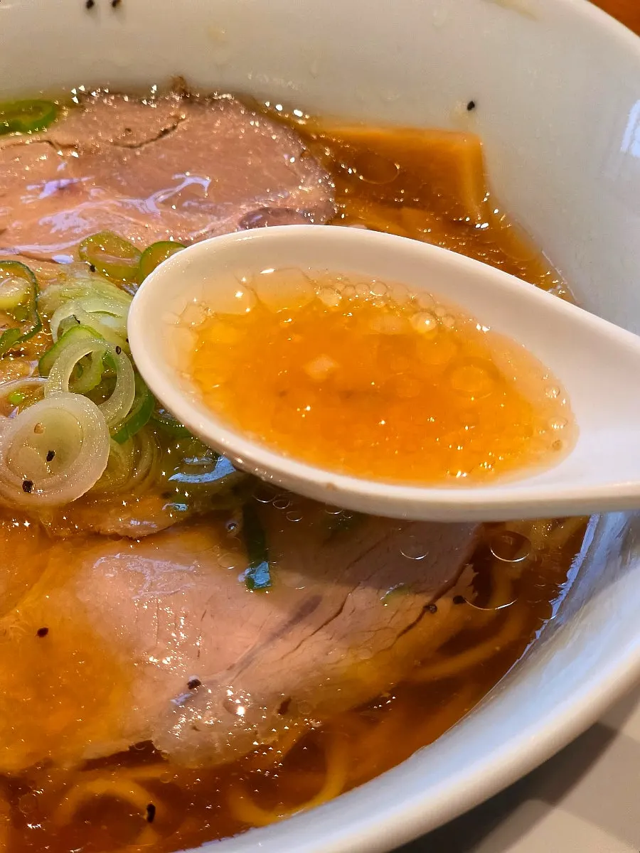 Clear soy sauce based broth of the shoyu ramen