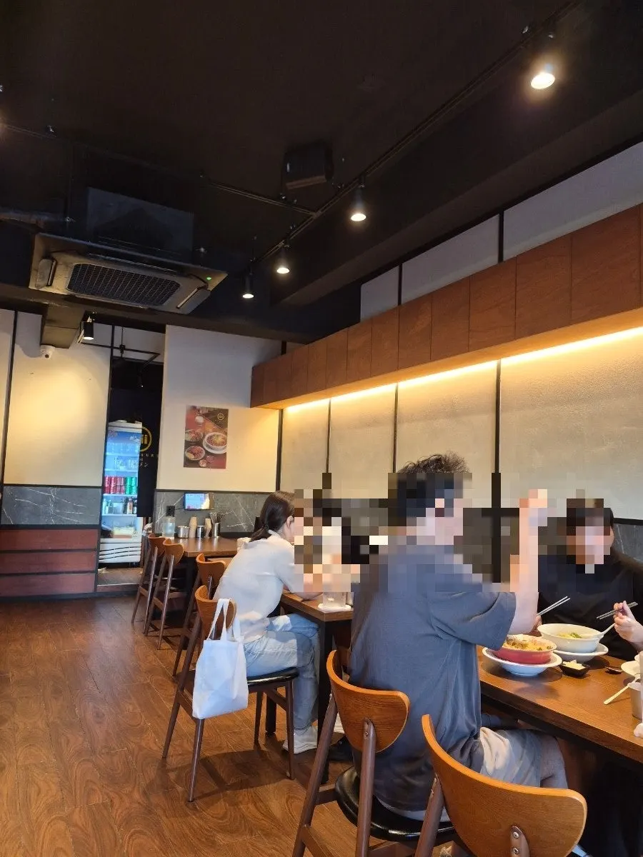 Wood-toned Japanese-style ramen shop interior