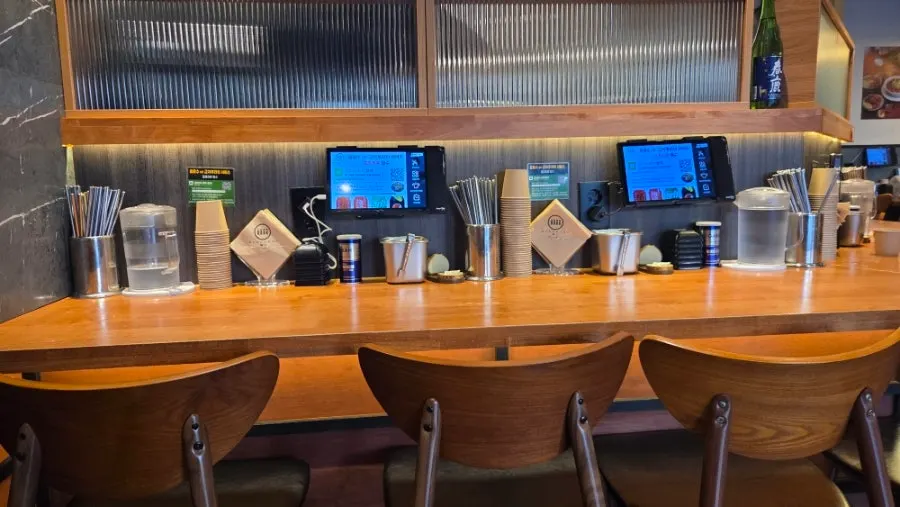 Bar seats with frosted glass facing the kitchen counter