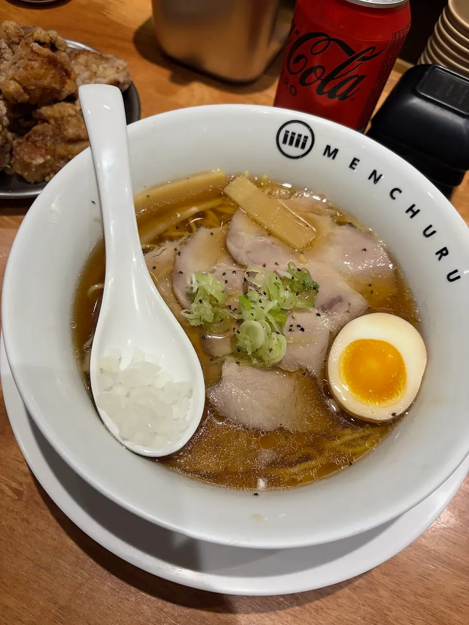 Two bowls of ramen with a side dish