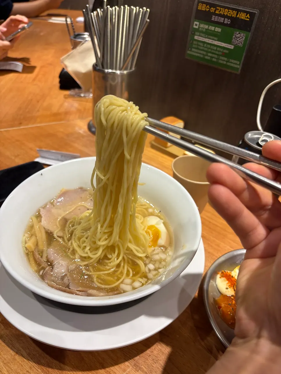 Chewy noodles lifted from a bowl of shoyu ramen