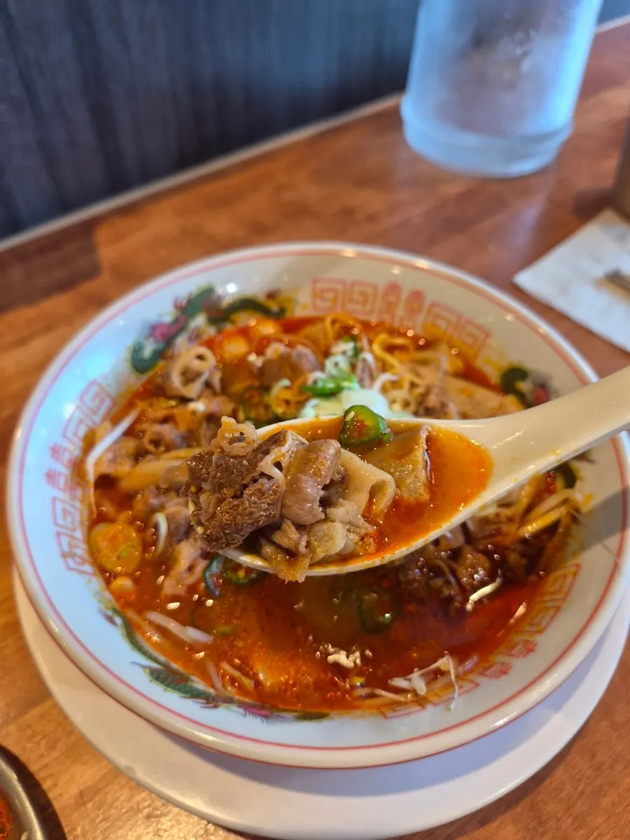 Red motsu ramen loaded with beef offal and bean sprouts