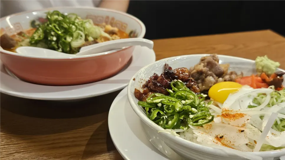 Table spread with motsu ramen and hormone-don