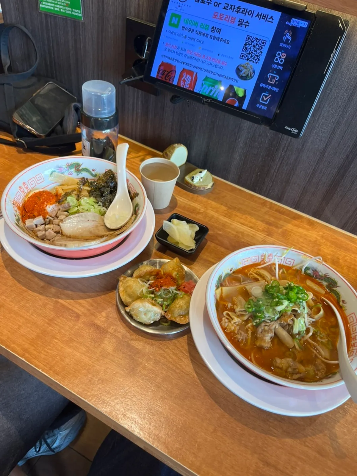 Table spread of motsu ramen and abura soba