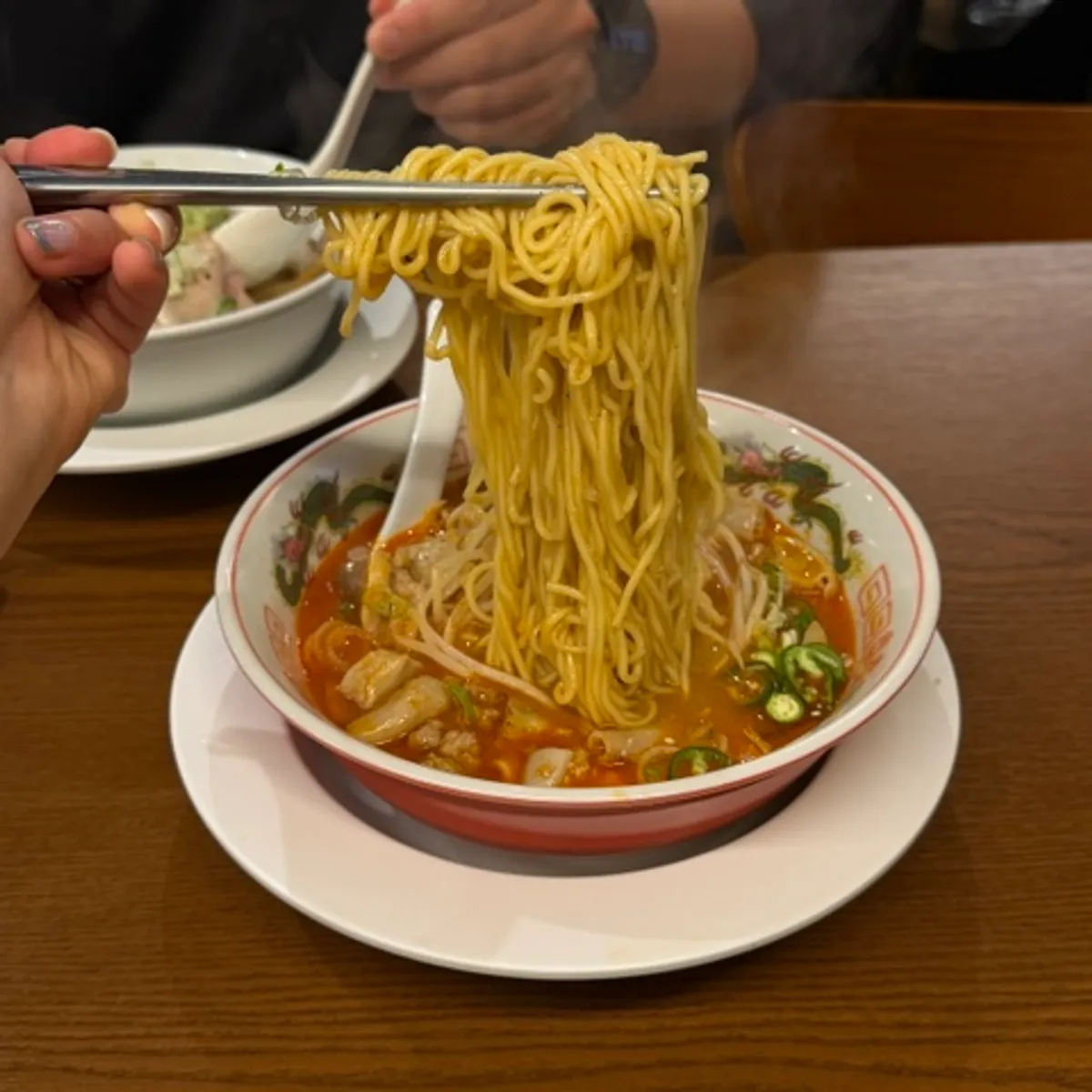 Close-up of the red, oily motsu ramen broth