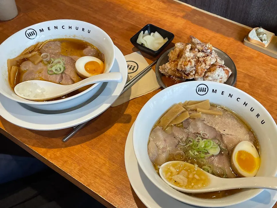 Table spread with ramen and sides