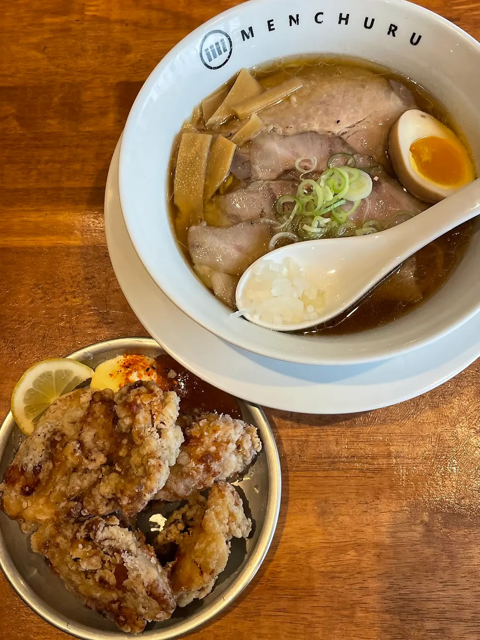 Vertical shot of noodles being lifted from the ramen