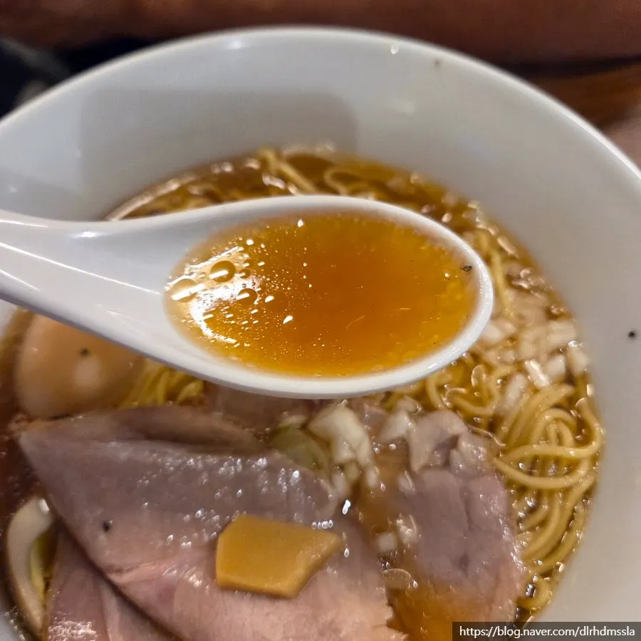 Ramen noodles lifted with chopsticks