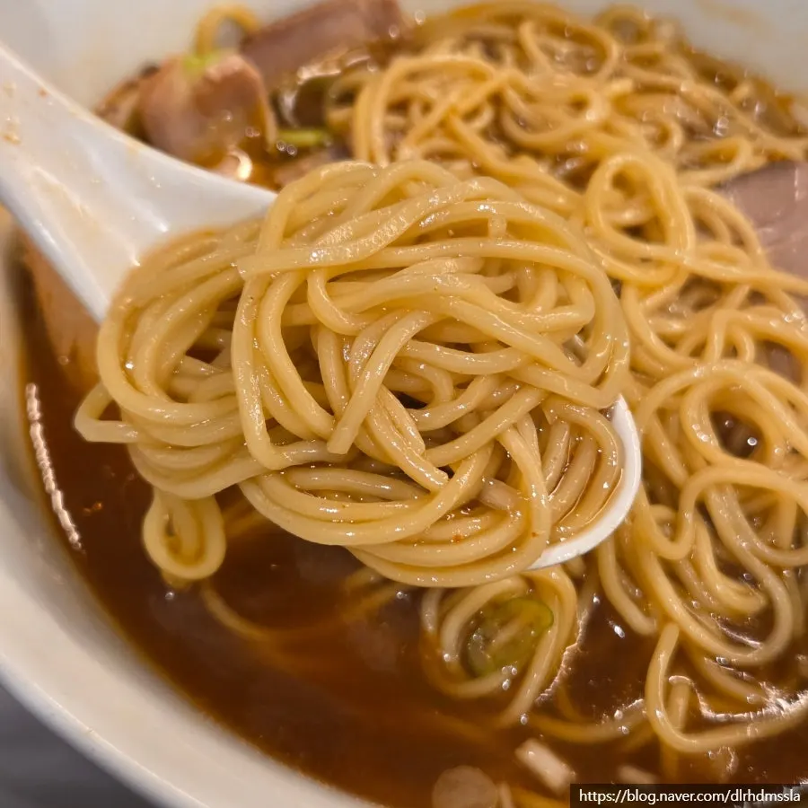Two bowls of shoyu ramen with differently colored broths