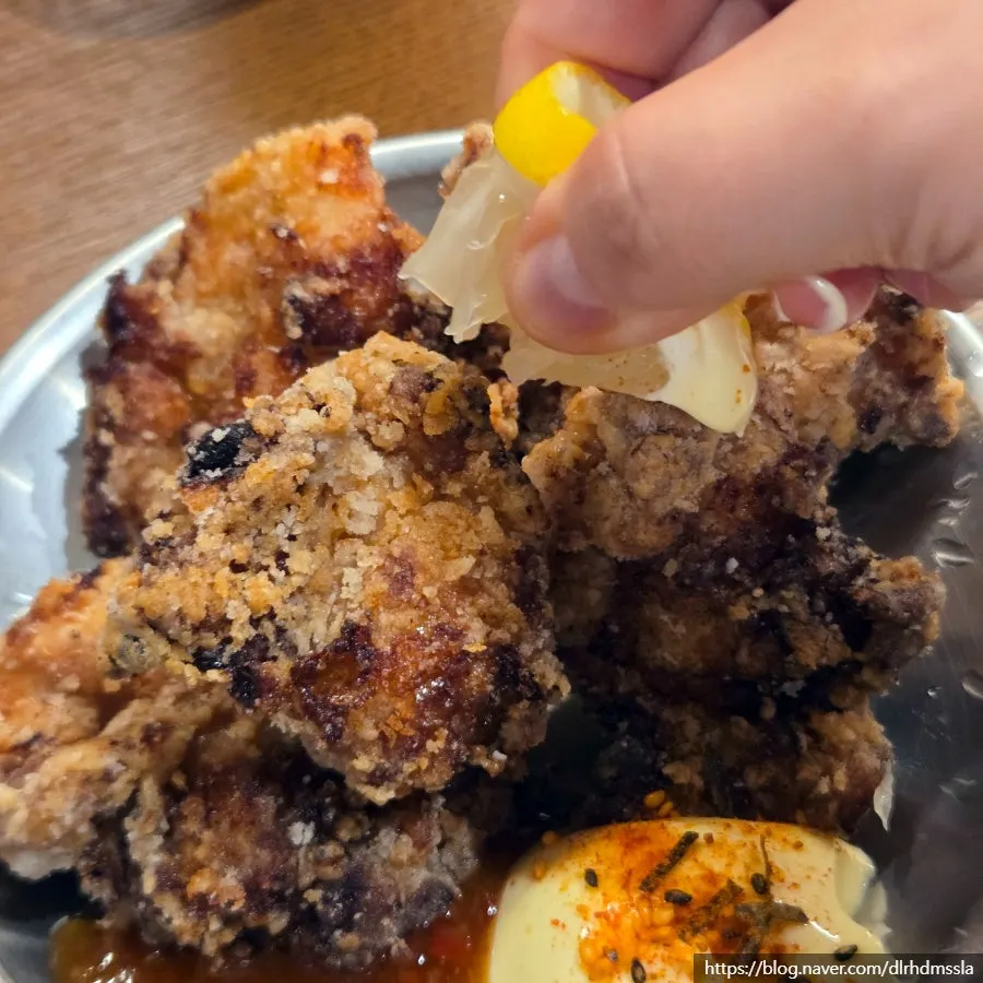 A large karaage with lemon juice squeezed on top