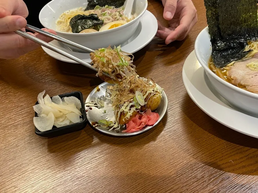 Ramen and takoyaki set out together on the table