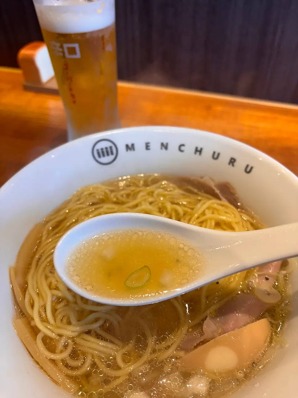 Asahi draft beer set beside the ramen