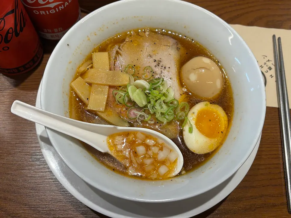 A bowl of spicy shoyu ramen with an added egg