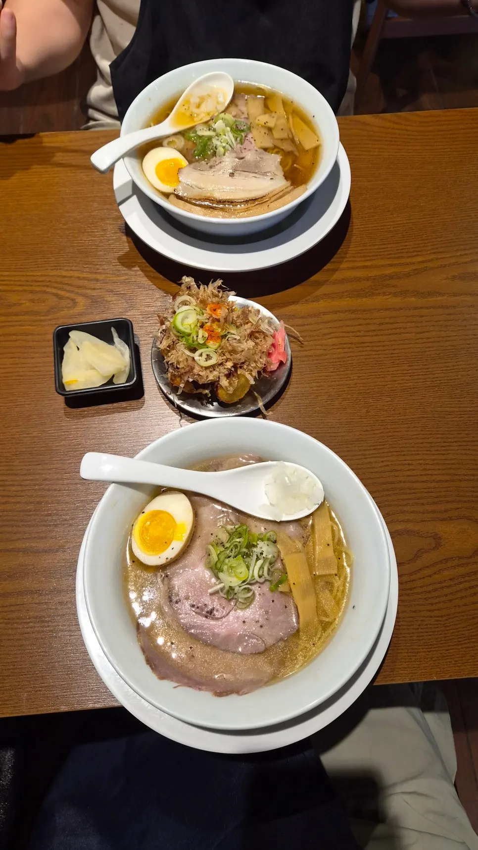 A bowl of shoyu ramen topped with 2 pieces of pork belly chashu