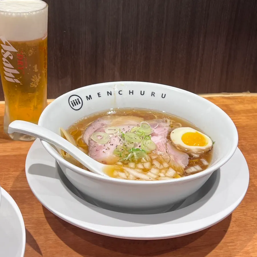 Table set with ramen and draft beer together