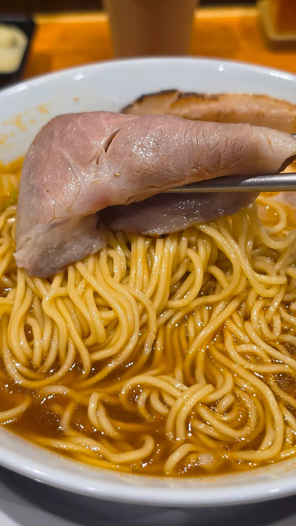 Extra pork belly chashu and noodles added to the spicy shoyu ramen