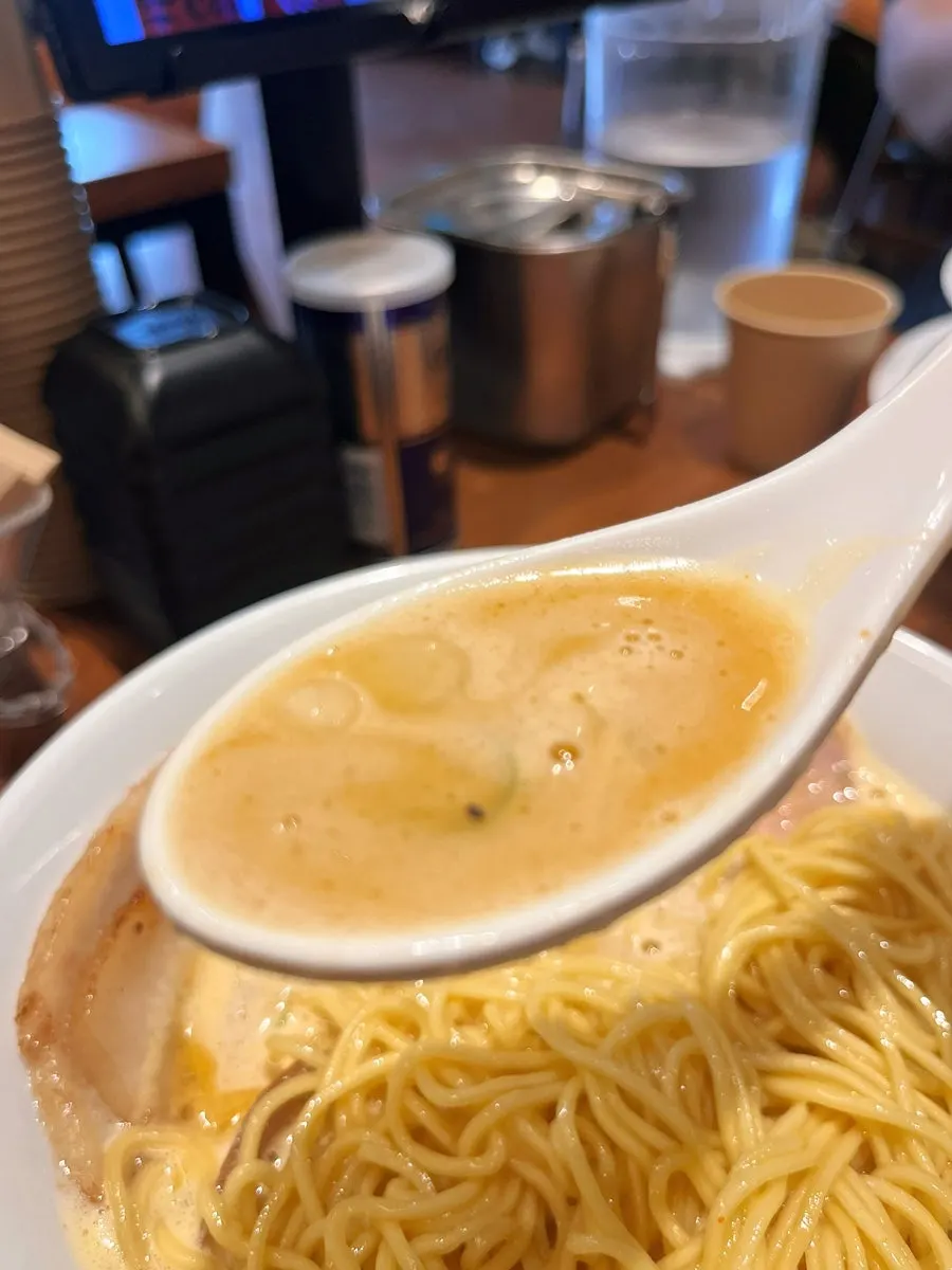 Standard chashu lifted with chopsticks