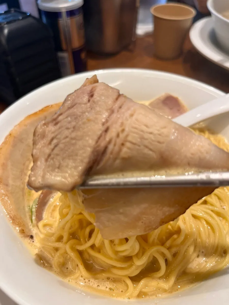 Onion served on a spoon alongside the broth