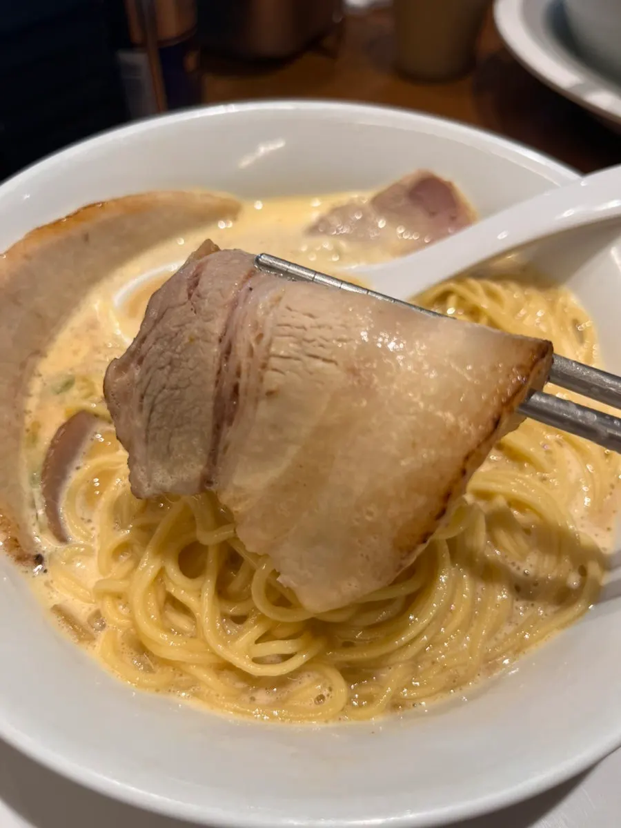 A spoonful of crunchy onion dipped in broth