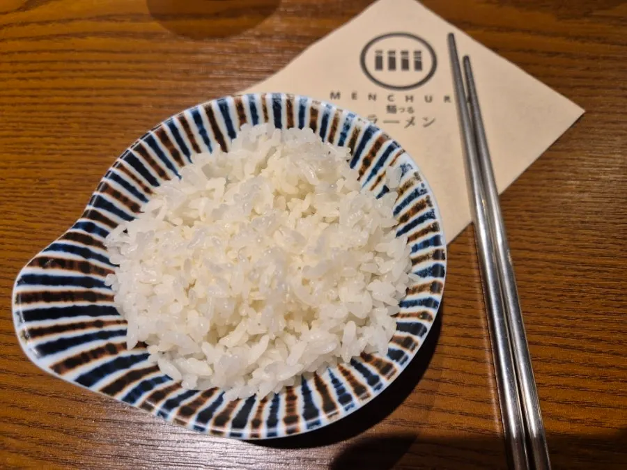 Close-up of ramen broth and chashu at Mentsuru
