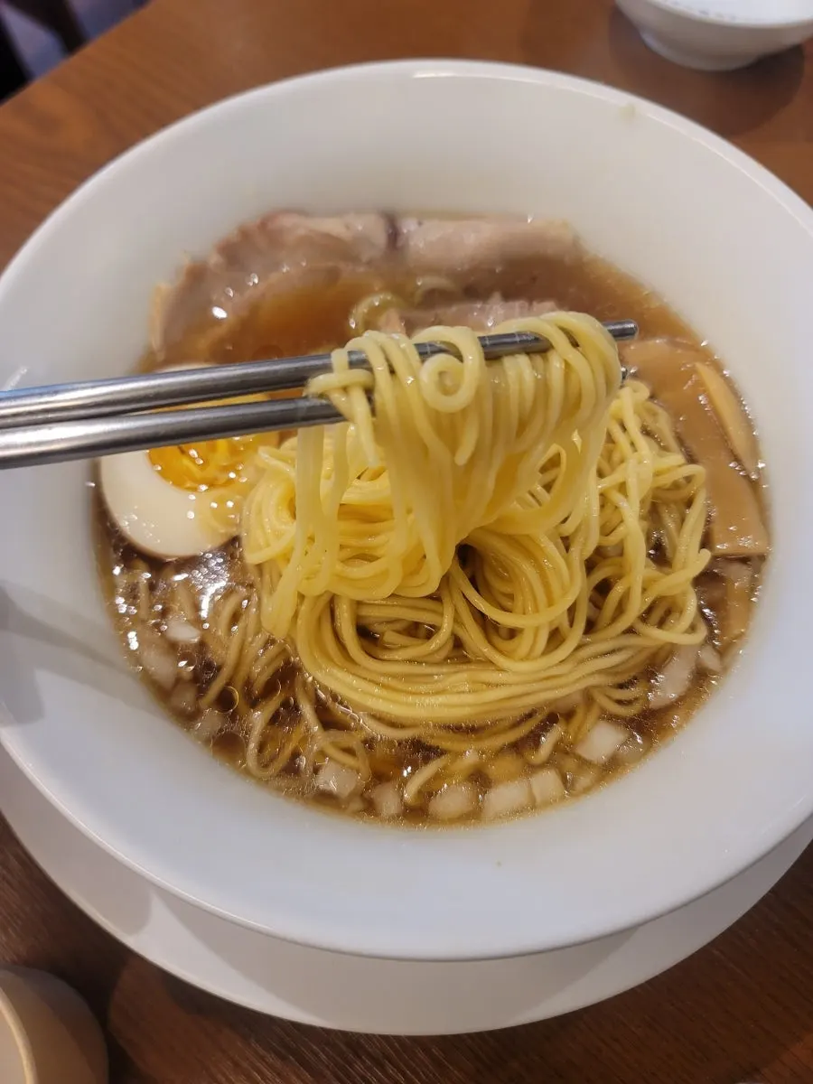 A spoonful of spicy shoyu ramen broth