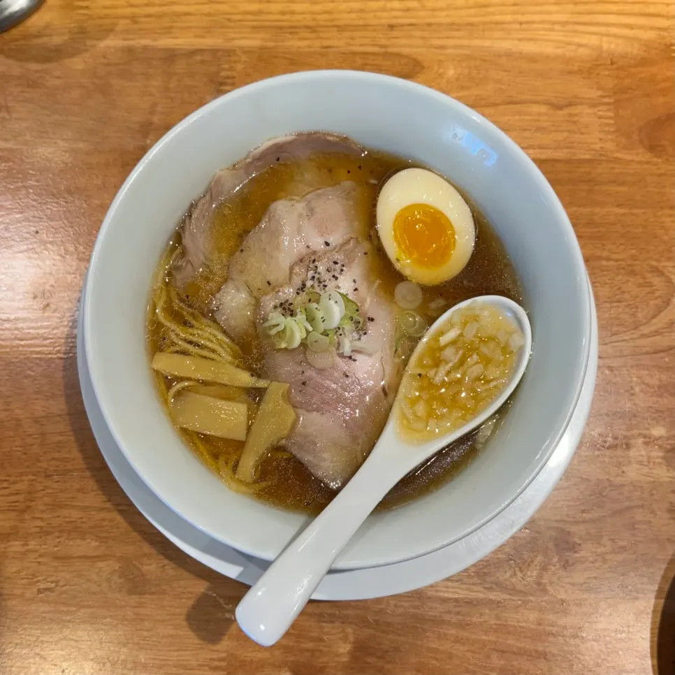 A bowl of shoyu ramen with clear brown broth