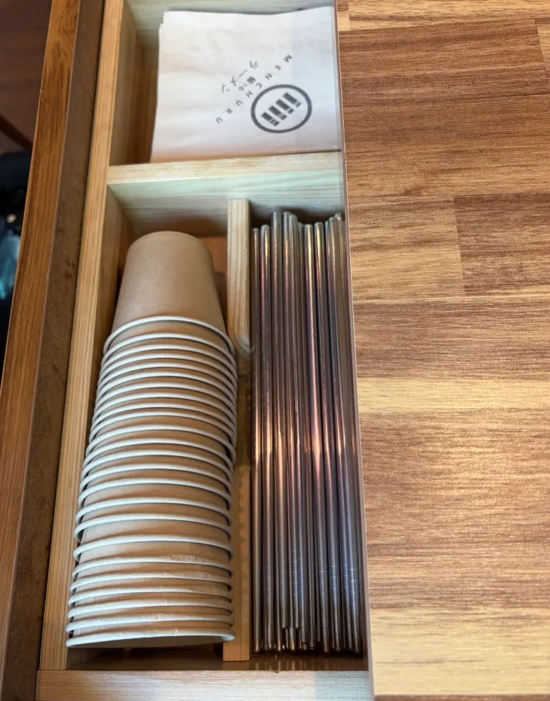 Chopsticks and water cup in the table drawer