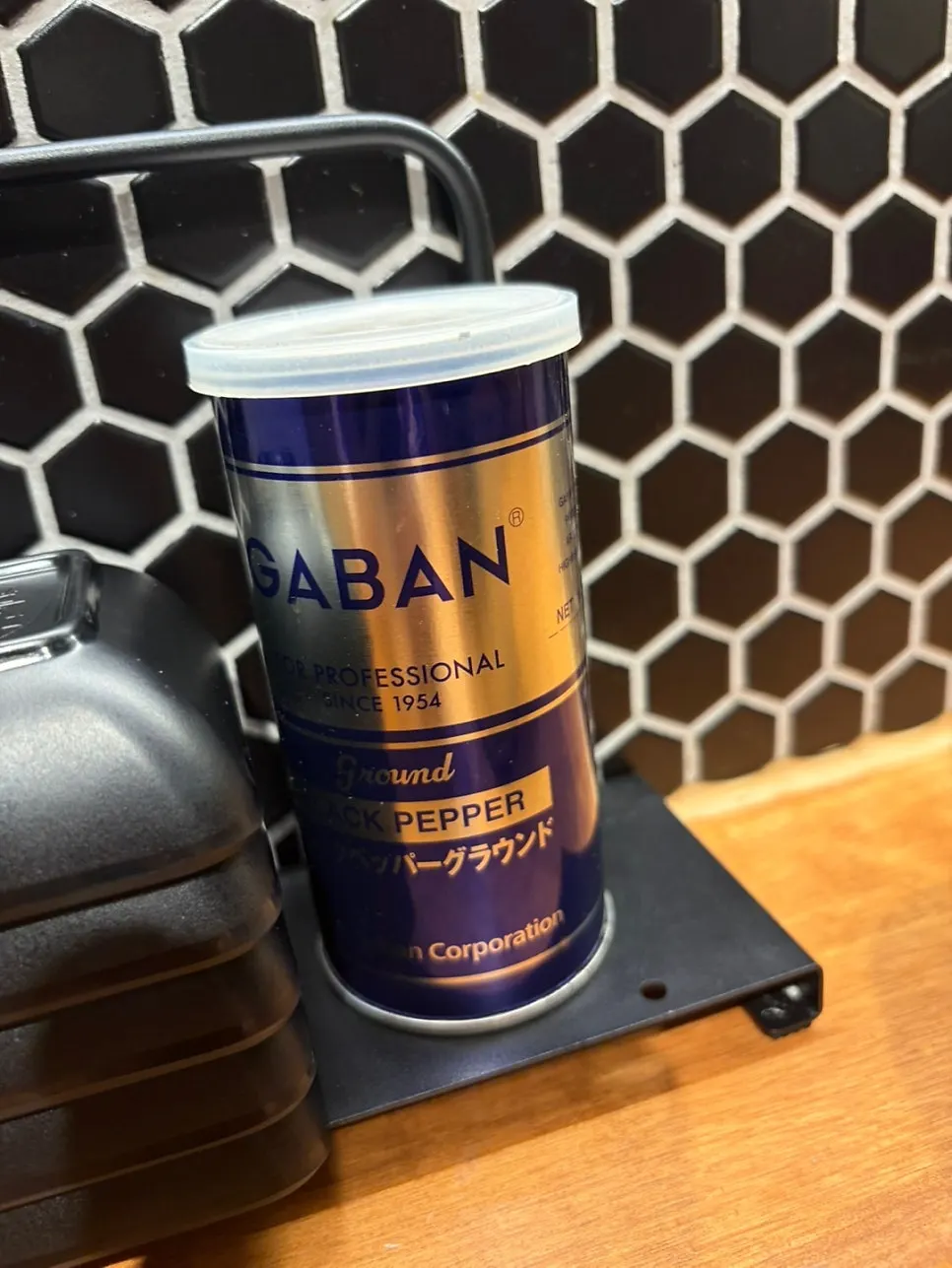 Close-up of a GABAN black pepper can on the table