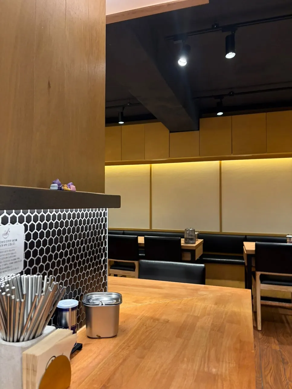 Interior of the restaurant with wooden decor and table seating