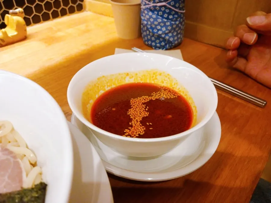 Dipping cold tsukemen noodles into the spicy-tangy sauce