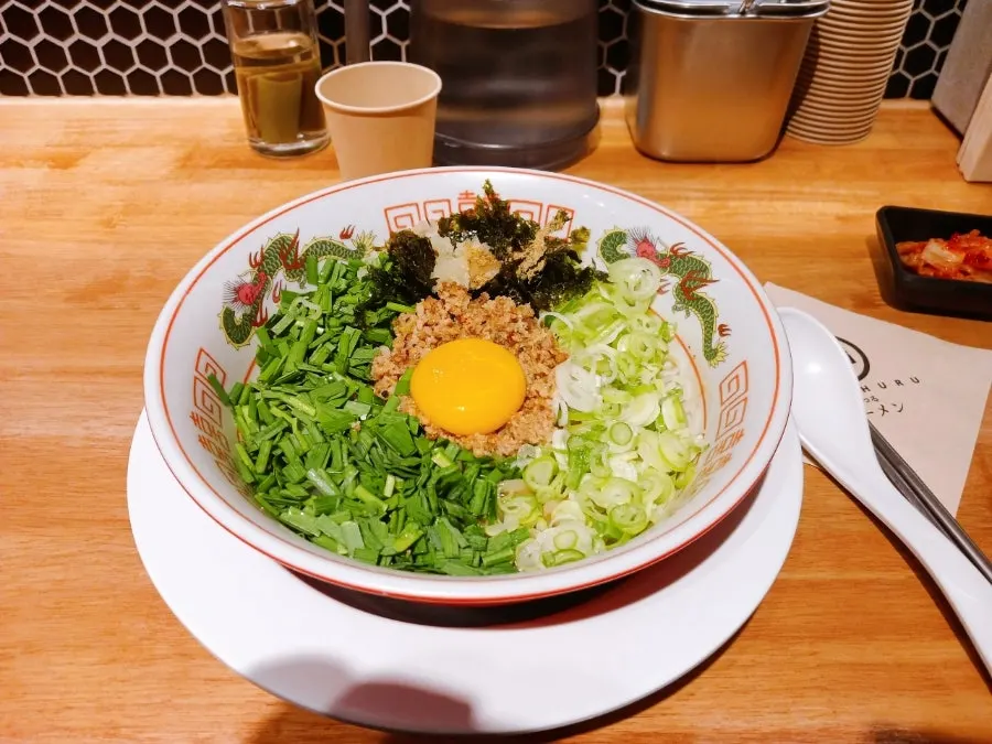 Mentsuru mazesoba topped with ingredients before mixing