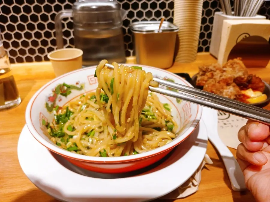Mazesoba topped with sautéed meat, seaweed, green onion, and chives